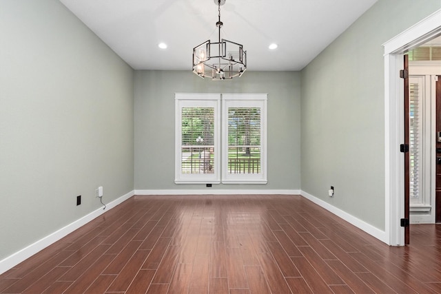 230009 Kama Dr, Porter, TX 77365 - unfurnished room with an inviting chandelier, baseboards, and dark wood finished floors