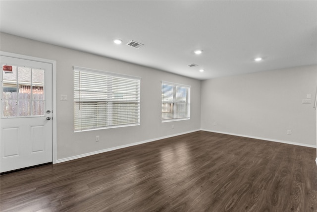 interior space with recessed lighting, baseboards, visible vents, and dark wood finished floors