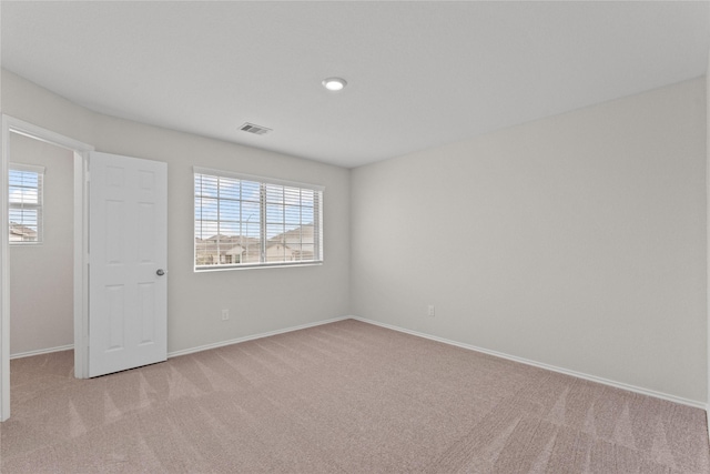 unfurnished room featuring carpet flooring, baseboards, and visible vents