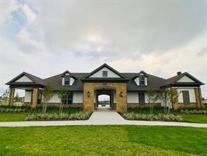 french country home featuring a front yard