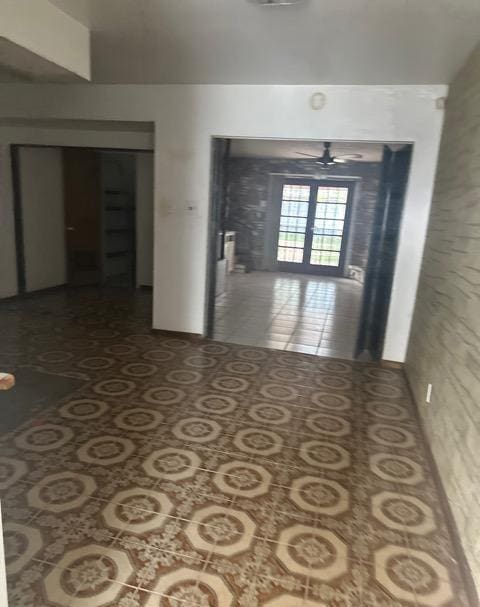 hall with tile patterned floors