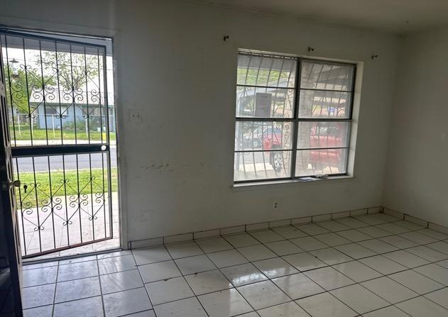 interior space featuring tile patterned flooring and baseboards