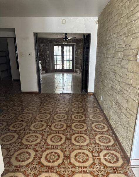 hall featuring french doors and tile patterned flooring