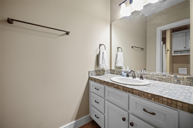 bathroom featuring vanity, baseboards, and toilet