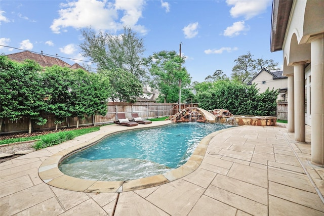 view of swimming pool with a water slide, a fenced backyard, a patio area, and a fenced in pool