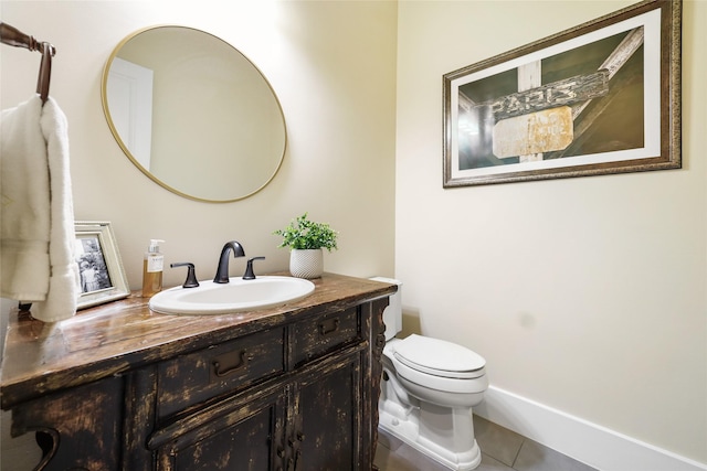 half bathroom with tile patterned flooring, toilet, and vanity