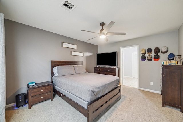 bedroom featuring baseboards, visible vents, light carpet, and ceiling fan