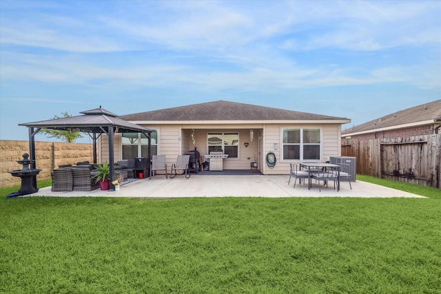 back of property with a fenced backyard, a patio area, a gazebo, central air condition unit, and a yard