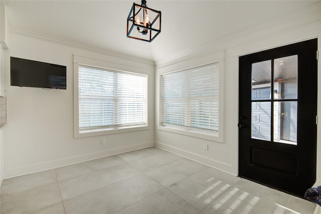 interior space featuring crown molding, light tile patterned flooring, baseboards, and a chandelier