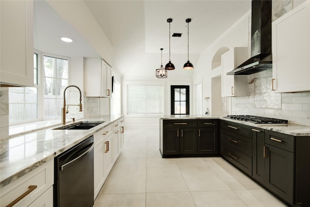 kitchen featuring a sink, wall chimney exhaust hood, white cabinetry, stainless steel gas stovetop, and dishwashing machine