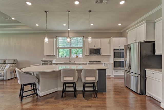 kitchen with light countertops, appliances with stainless steel finishes, white cabinetry, and visible vents