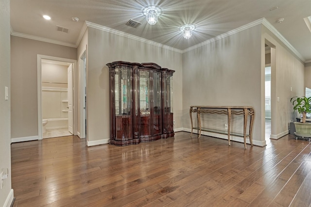 spare room with visible vents, hardwood / wood-style flooring, and a baseboard radiator