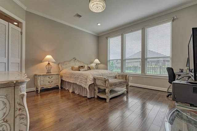 bedroom featuring baseboards, visible vents, ornamental molding, and wood finished floors