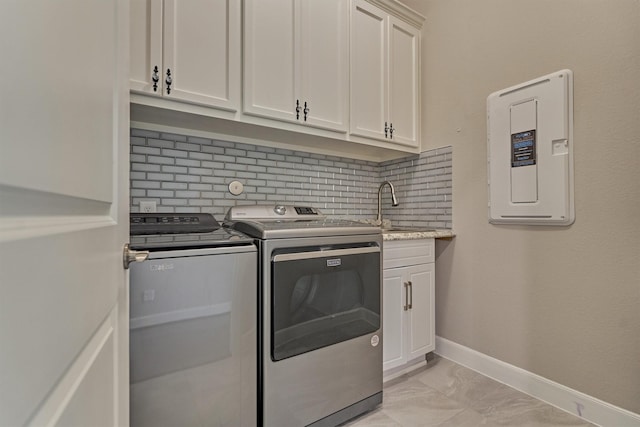 laundry room with marble finish floor, electric panel, washing machine and clothes dryer, a sink, and cabinet space