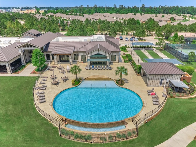 pool with a lawn and a residential view