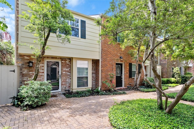 townhome / multi-family property featuring brick siding