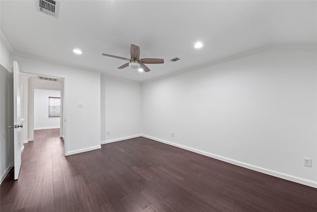 spare room featuring visible vents, baseboards, ceiling fan, and dark wood-style floors
