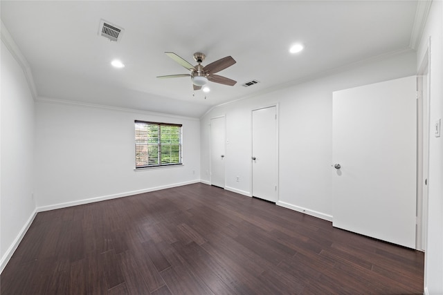 unfurnished bedroom featuring crown molding, baseboards, visible vents, and dark wood-type flooring
