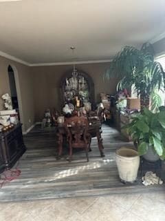 15827 Maple Shores Dr, Houston, TX 77044 - dining room with arched walkways, crown molding, and a chandelier