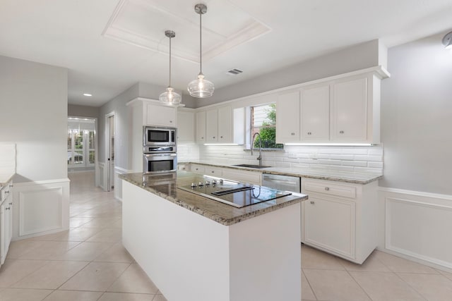 kitchen featuring a sink, appliances with stainless steel finishes, light tile patterned floors, white cabinetry, and light stone countertops