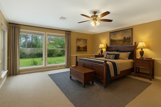 bedroom featuring carpet floors, ornamental molding, a ceiling fan, and baseboards