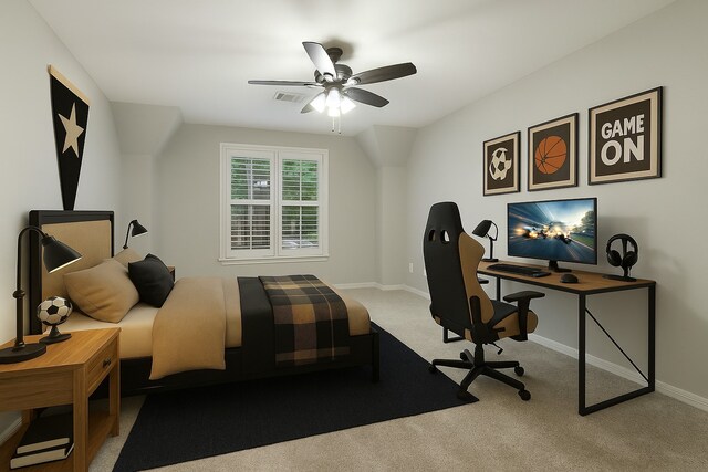bedroom featuring light colored carpet, a desk, baseboards, and a ceiling fan