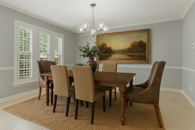 dining space with light tile patterned floors, a chandelier, ornamental molding, and baseboards