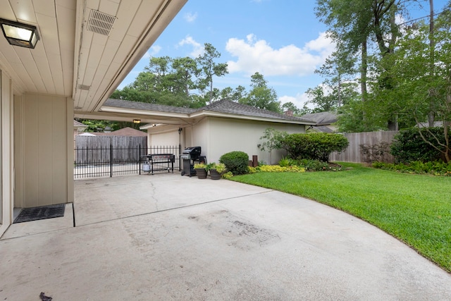 view of patio with concrete driveway, a grill, and a garage