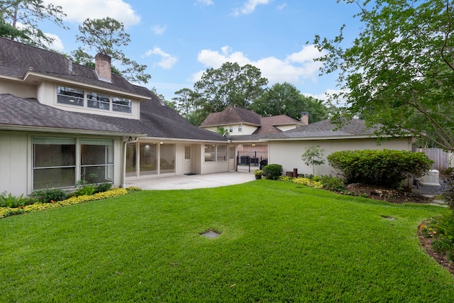 rear view of house with a patio area and a chimney
