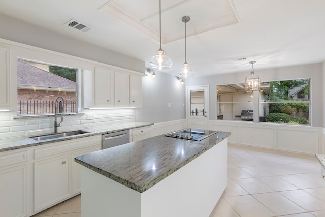 kitchen with a sink, dishwasher, black electric stovetop, a kitchen island, and backsplash