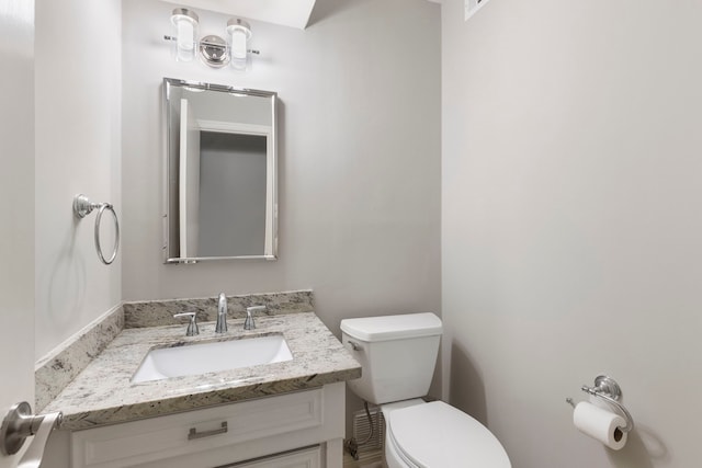 bathroom with toilet and vanity