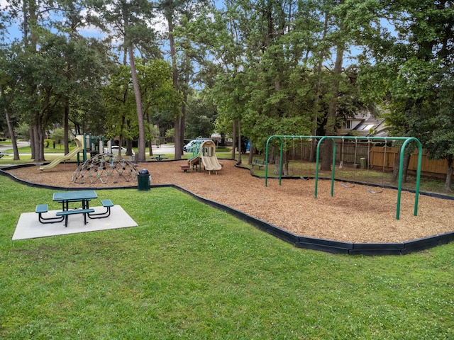 community jungle gym featuring a lawn