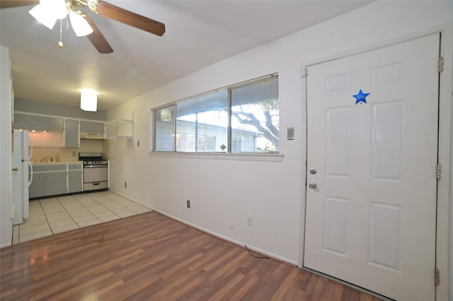 entrance foyer featuring baseboards, light wood finished floors, and ceiling fan