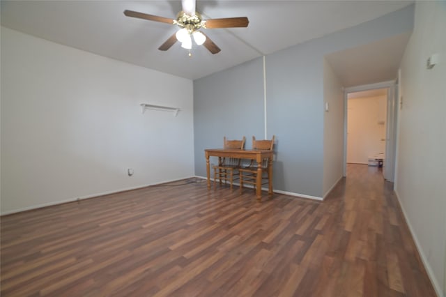 spare room featuring a ceiling fan, baseboards, and wood finished floors