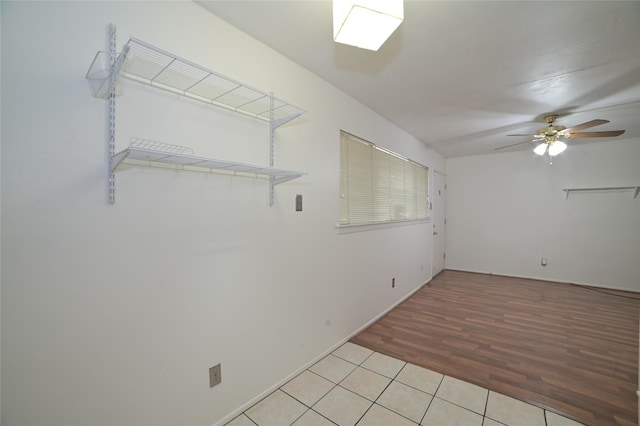 unfurnished room with baseboards, a ceiling fan, and light tile patterned flooring