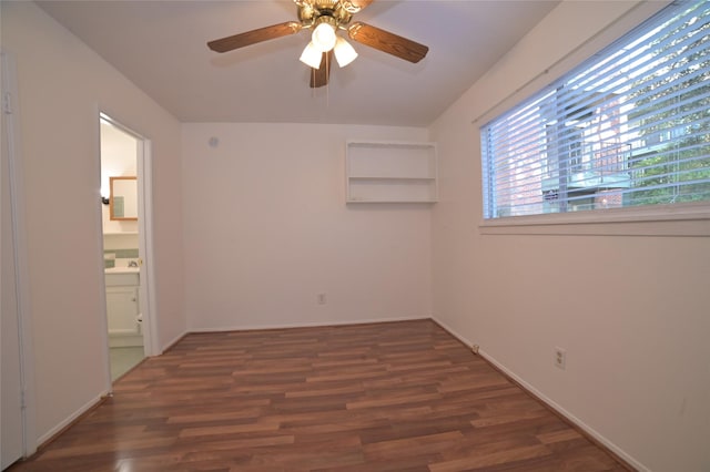spare room with baseboards, a ceiling fan, and wood finished floors