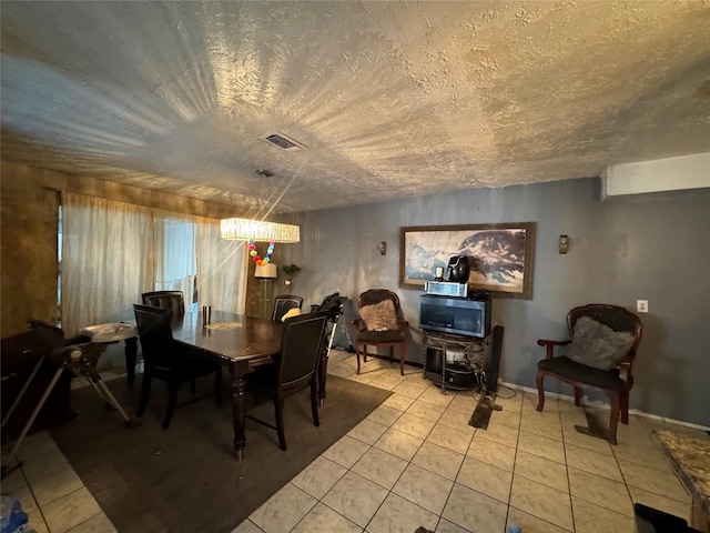 dining room featuring visible vents, a textured ceiling, and light tile patterned floors