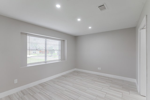 spare room featuring recessed lighting, baseboards, and visible vents