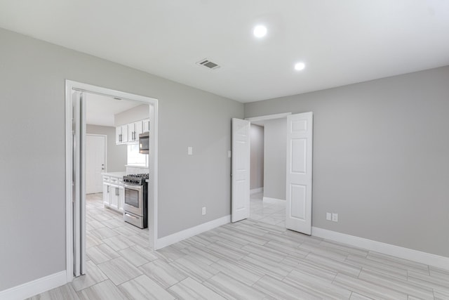 unfurnished bedroom with visible vents, recessed lighting, baseboards, and wood tiled floor