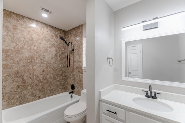 bathroom with visible vents, vanity, toilet, and shower / washtub combination