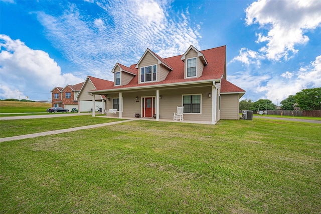 view of front of property featuring a porch, central AC, fence, and a front lawn