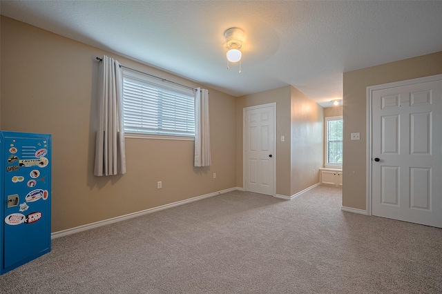 unfurnished bedroom featuring carpet floors and baseboards