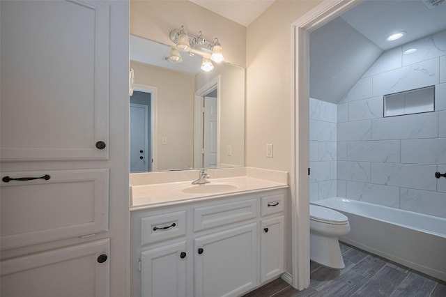 full bath featuring vaulted ceiling, shower / tub combination, wood finished floors, vanity, and toilet