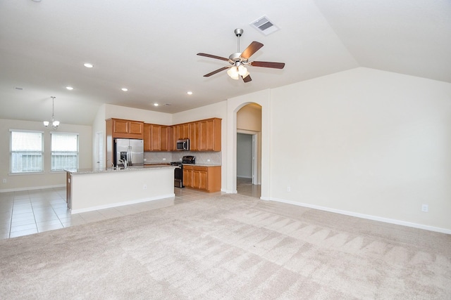18007 Alora Springs Trce, Cypress, TX 77433 - kitchen featuring stainless steel appliances, vaulted ceiling, open floor plan, arched walkways, and a ceiling fan