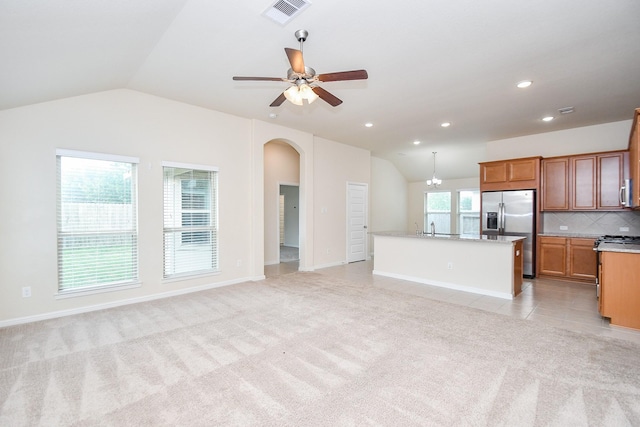 18007 Alora Springs Trce, Cypress, TX 77433 - unfurnished living room featuring vaulted ceiling, light carpet, arched walkways, a ceiling fan, and recessed lighting