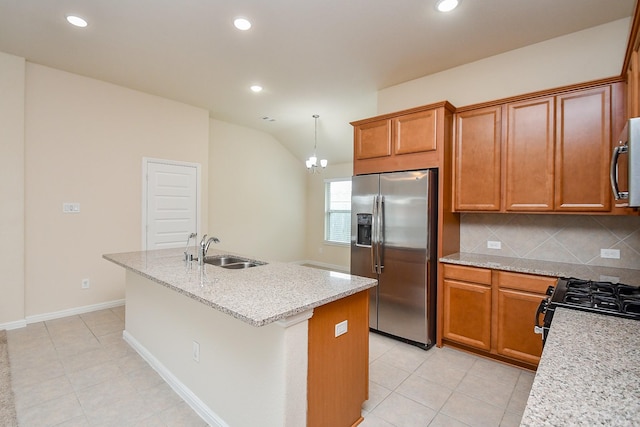 18007 Alora Springs Trce, Cypress, TX 77433 - kitchen featuring stainless steel refrigerator with ice dispenser, a sink, black range with gas cooktop, a center island with sink, and decorative backsplash