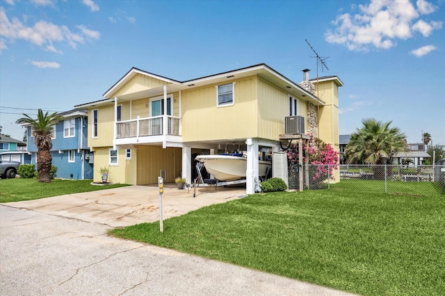 back of property featuring a yard, fence, driveway, and a carport
