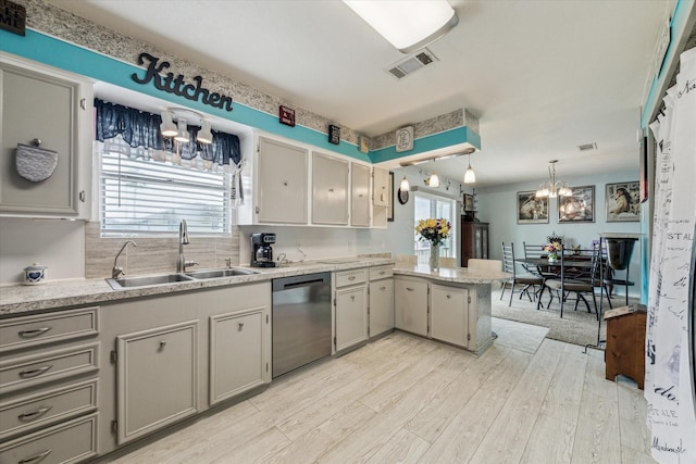 kitchen with visible vents, a peninsula, a chandelier, a sink, and dishwasher