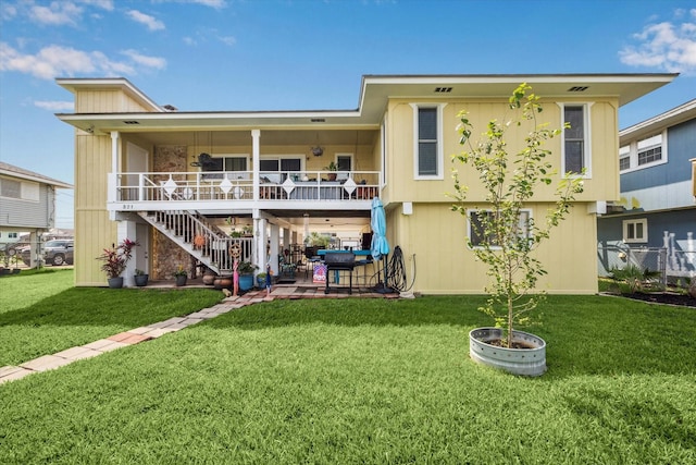 back of house with a yard, a patio area, and stairway