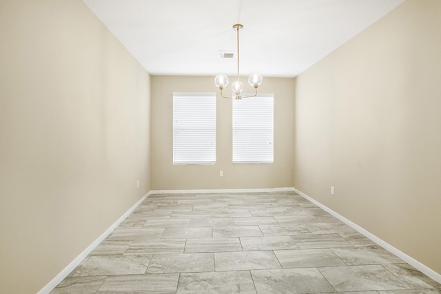 unfurnished room featuring an inviting chandelier, marble finish floor, baseboards, and visible vents